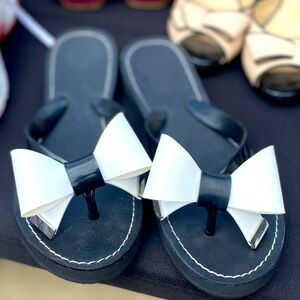 Black and white bow flip flops.  Size 7.
